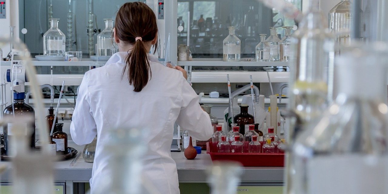 Woman in a laboratory facing away from the camera