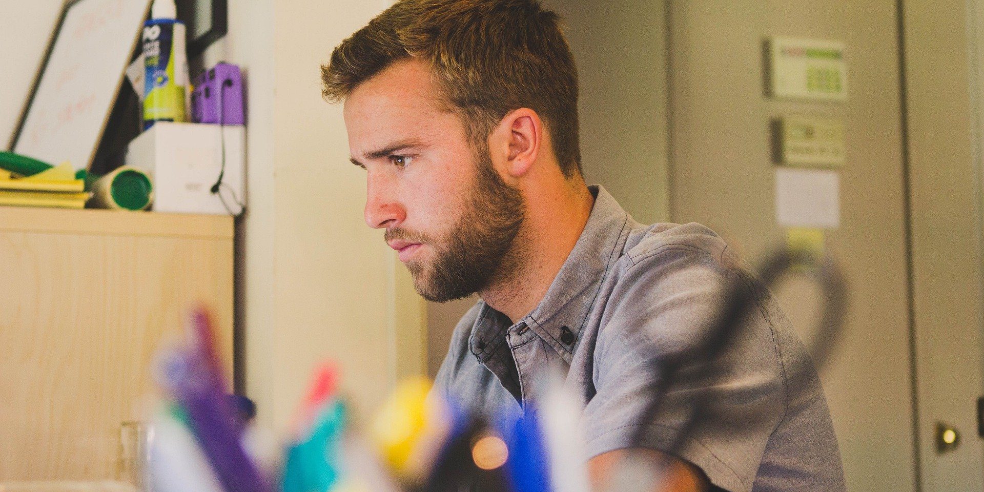 Man concentrates on work at his desk.