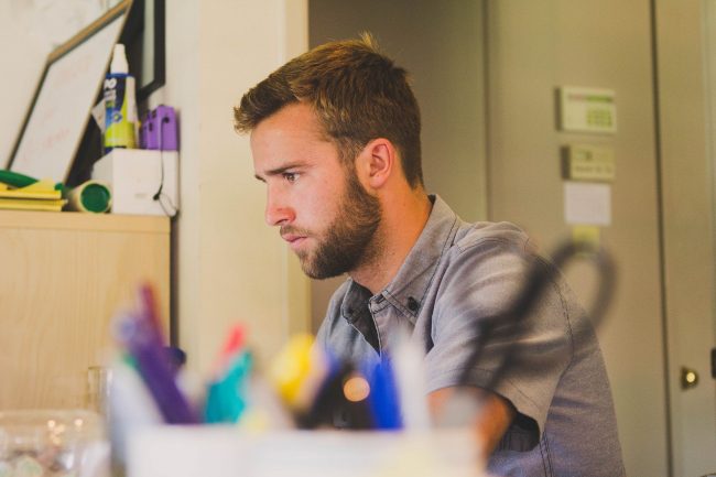 Man concentrates on work at his desk.