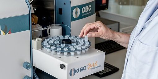 laboratory 2815639 340 Medical professional in white coat places vile in laboratory machine.